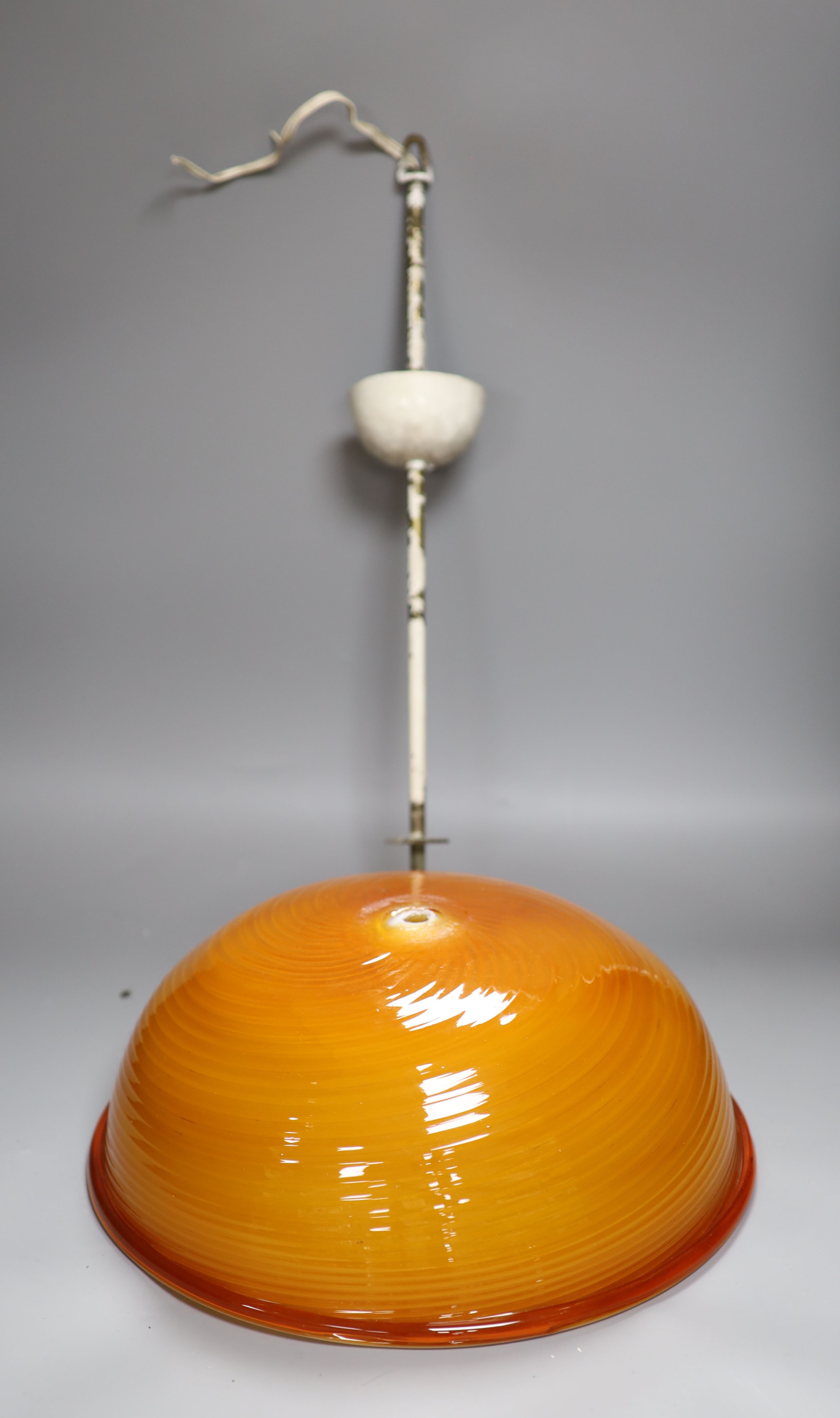 An Italian burnt orange glass circular ceiling shade